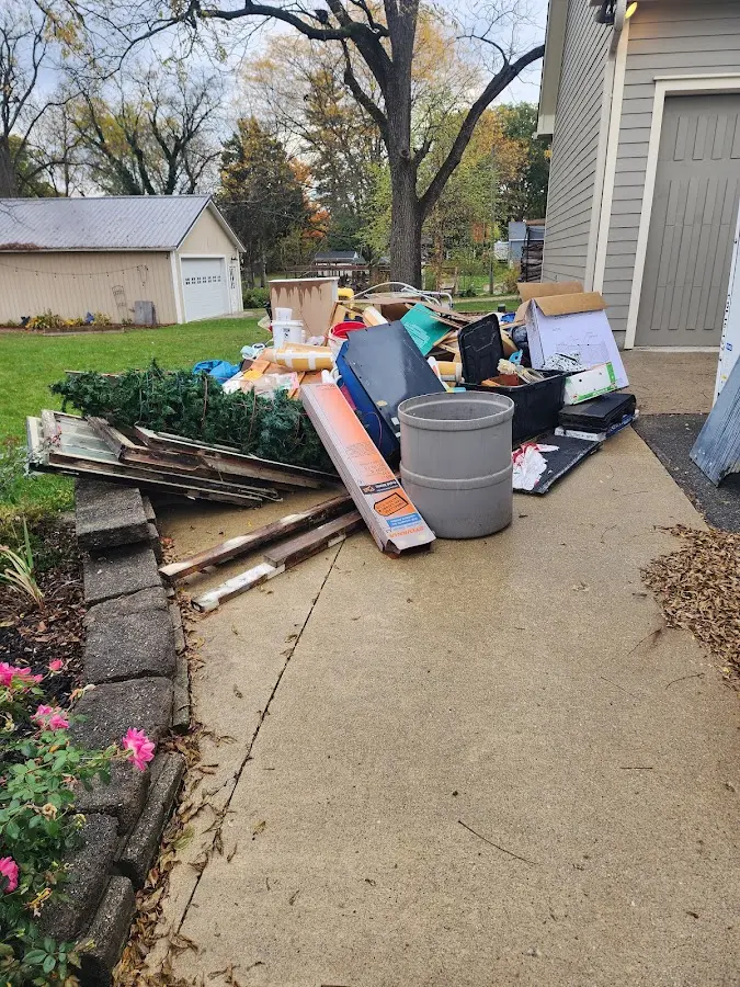 Dumpster being loaded with debris for Estate Cleanout Dumpster Rental in Mocksville